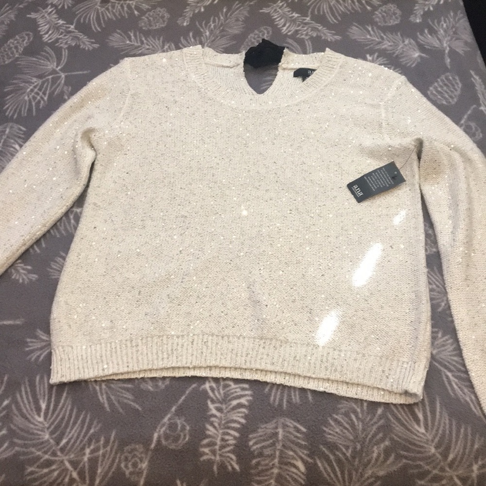 White sparkly sweater.